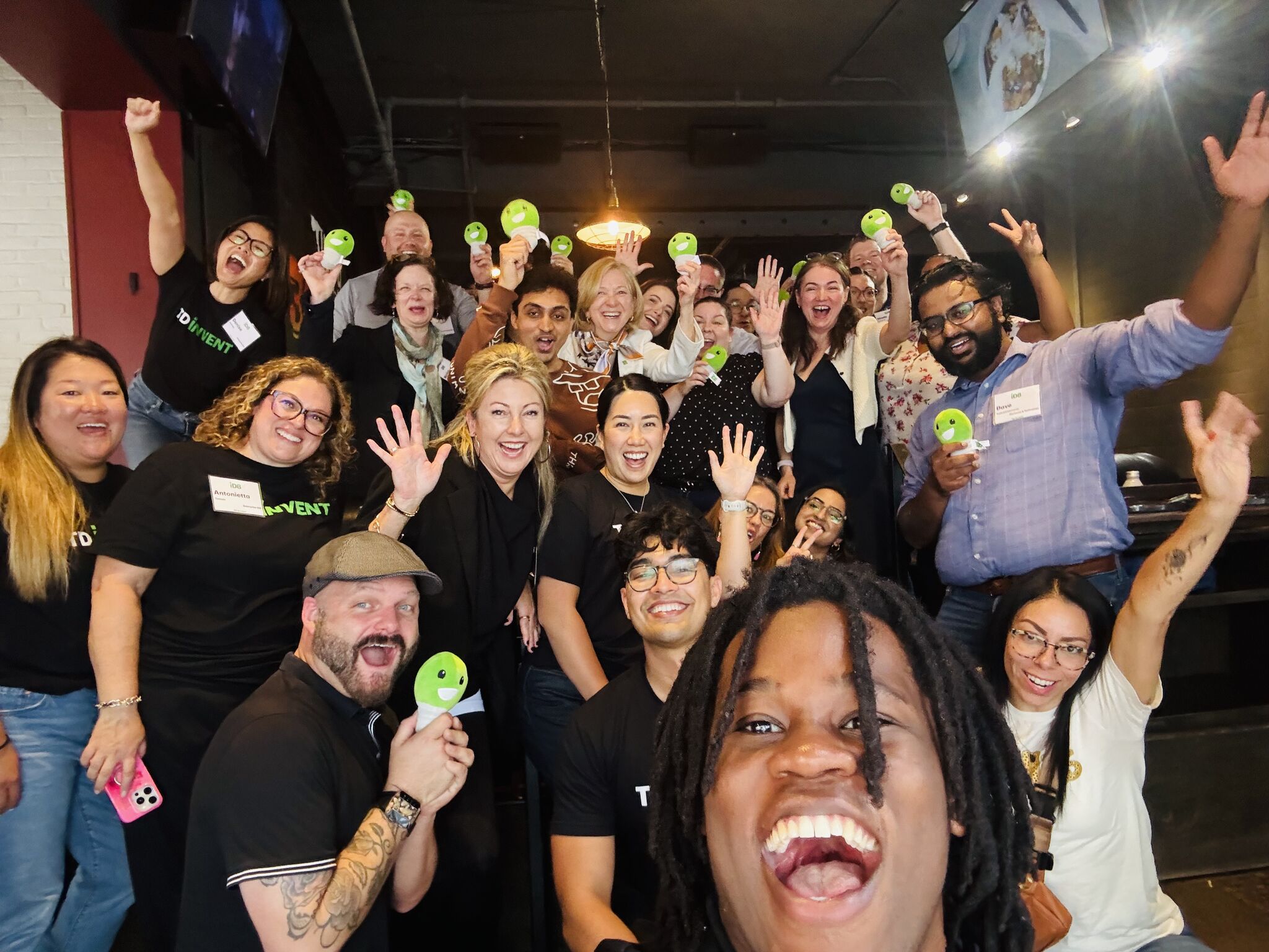 Group of TD Bank employees celebrating iD8 innovation program champions, collaborating to turn ideas into real solutions and impact.